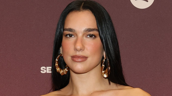 Dua Lipa wearing large hoop earrings